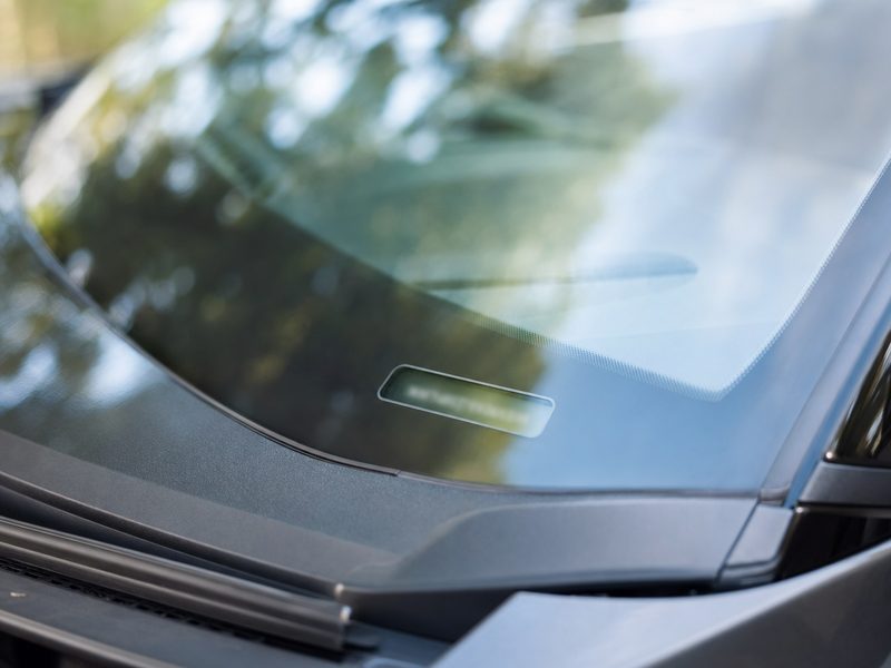A VIN plate at the base of a car windshield